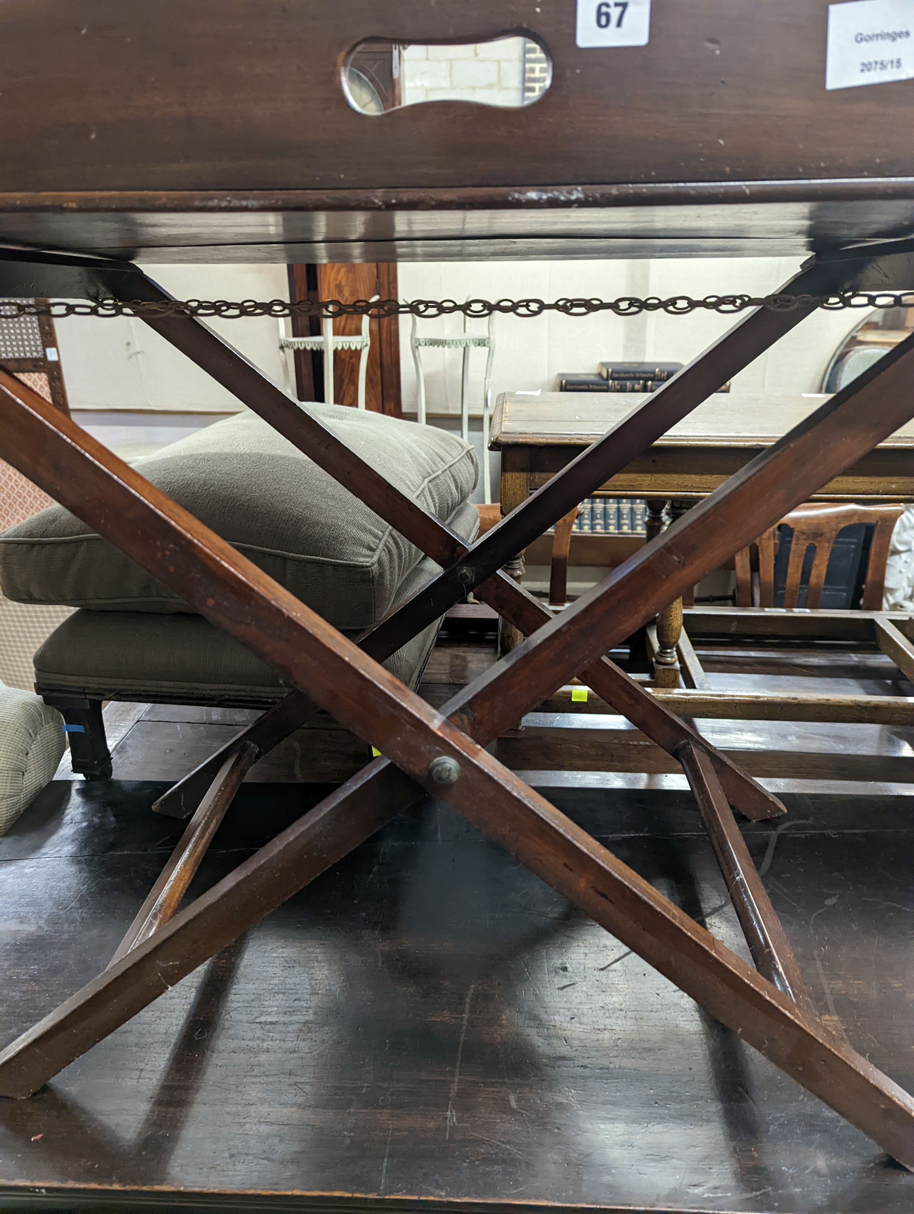 A 19th century rectangular mahogany butler's tray on folding stand, width 24cm, depth 49cm, height 71cm